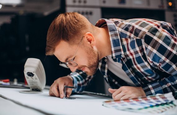 man-working-printing-house-with-paper-paints